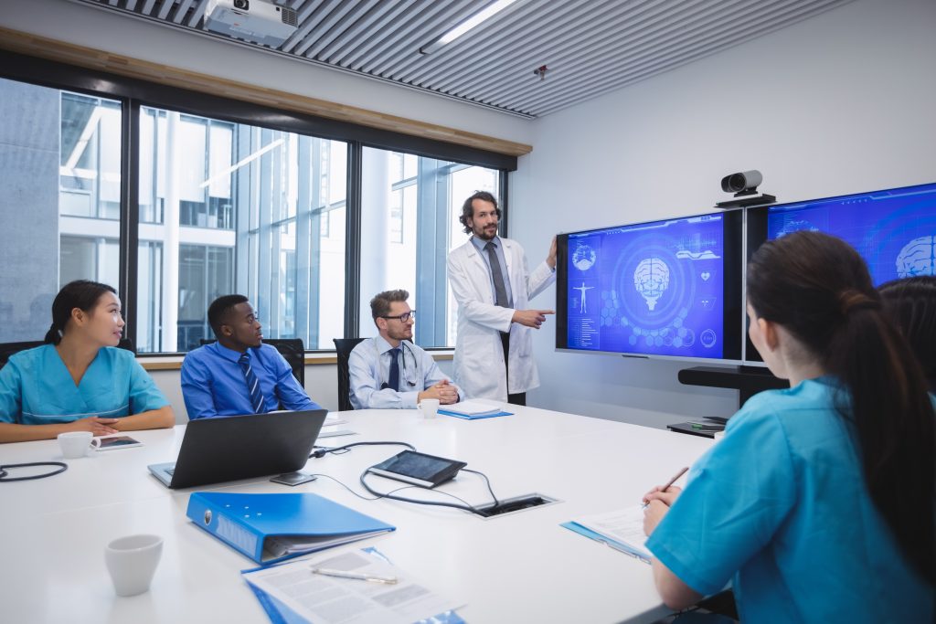 Doctor giving presentation to team