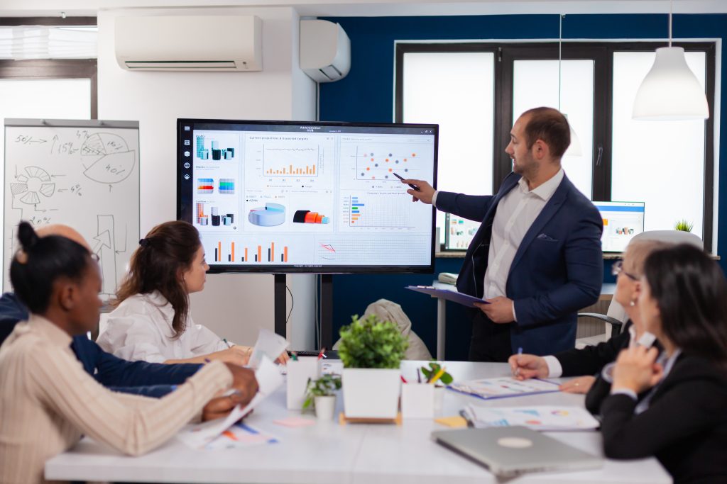 Manager holding briefing presentation in conference room