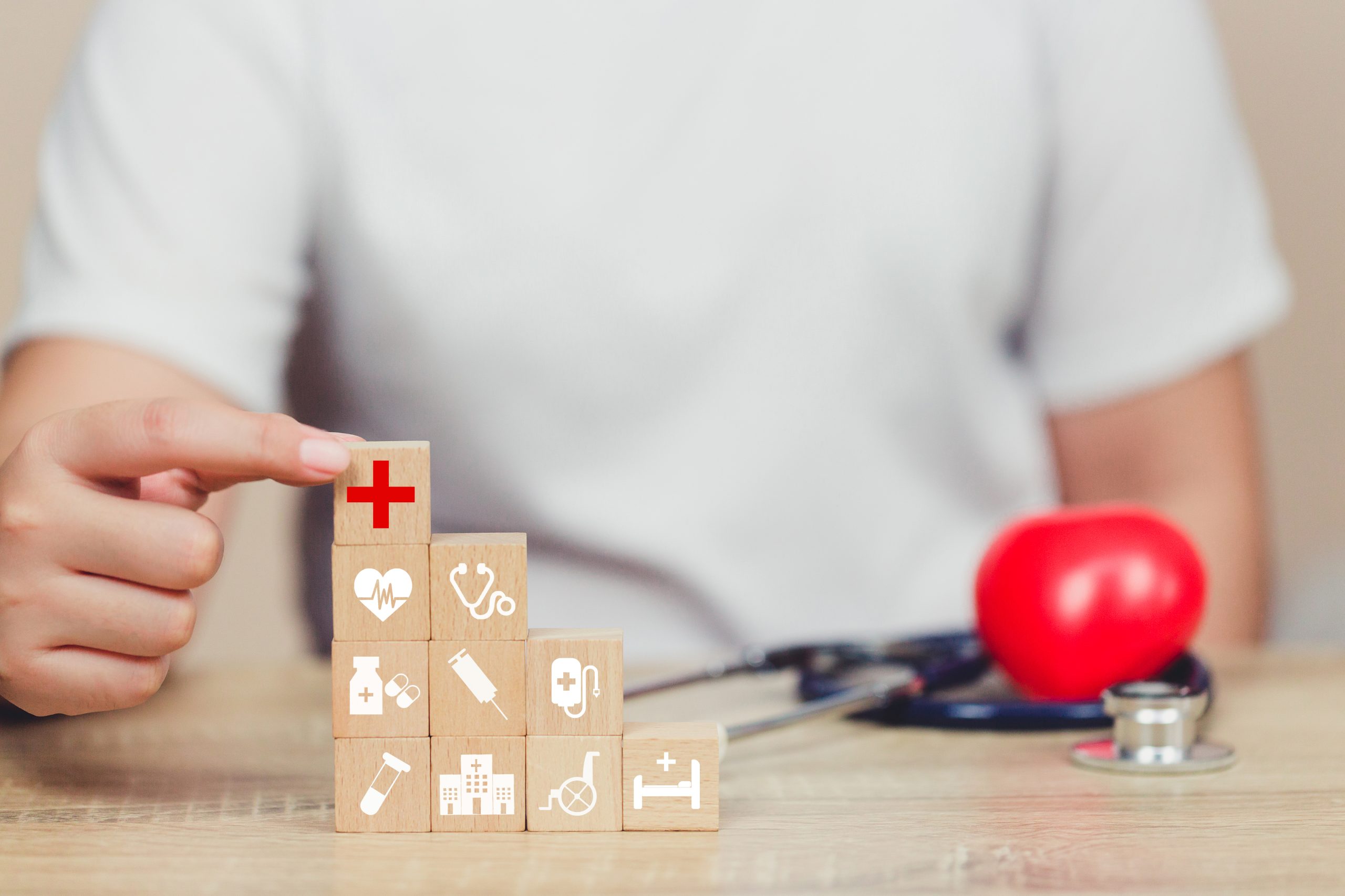 midsection-man-stacking-wooden-block-with-symbol-table