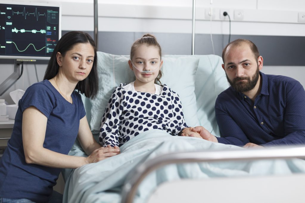 Portrait of sick little girl with parents