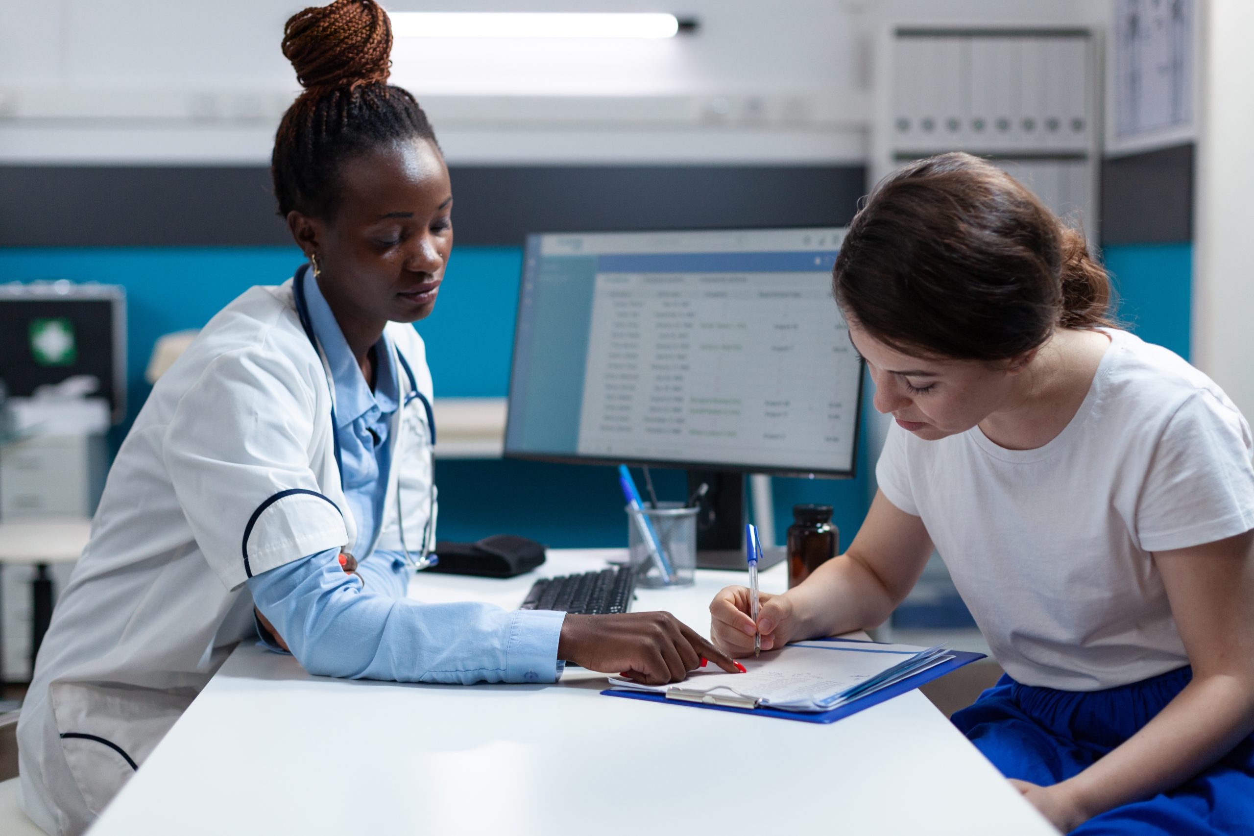 Woman patient signing medical documents