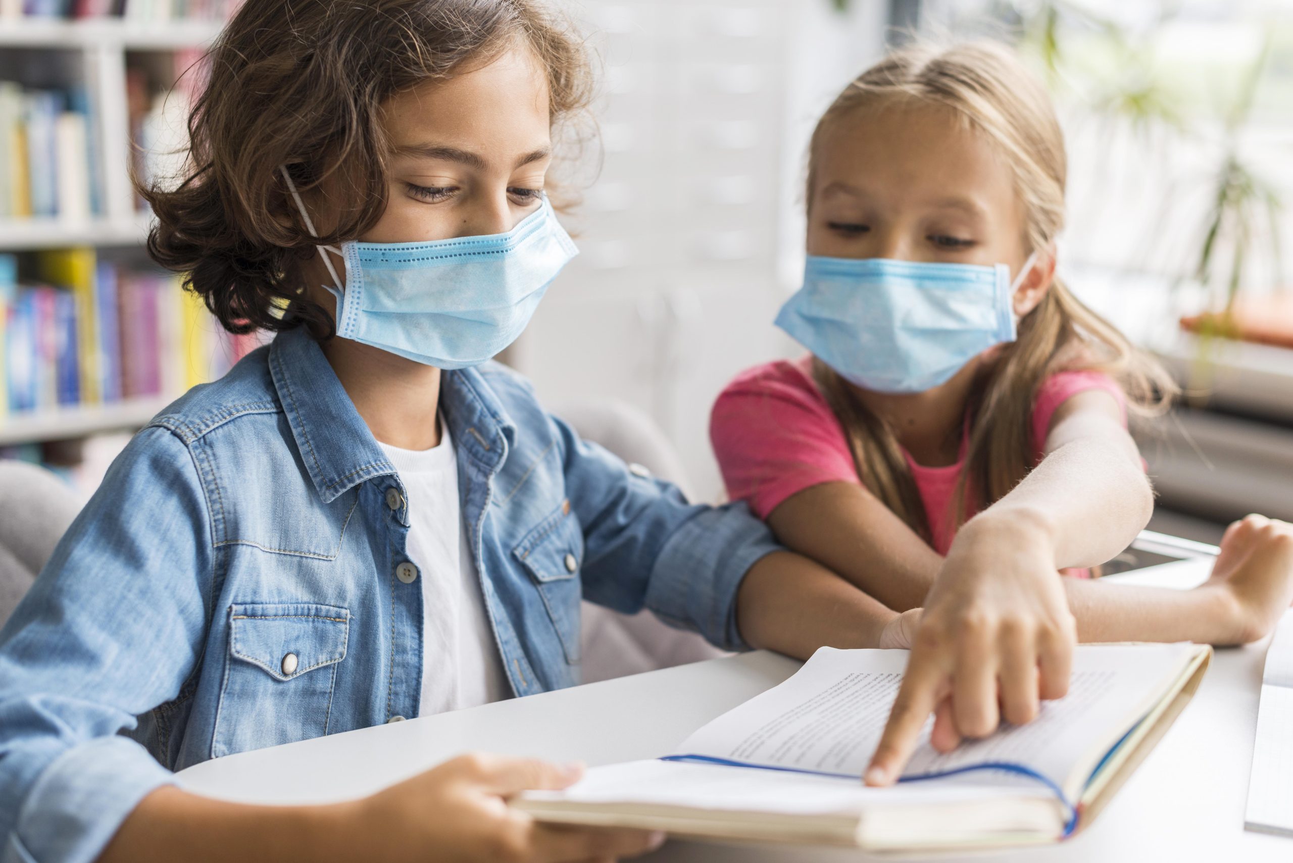 colleagues doing their homework while wearing face mask