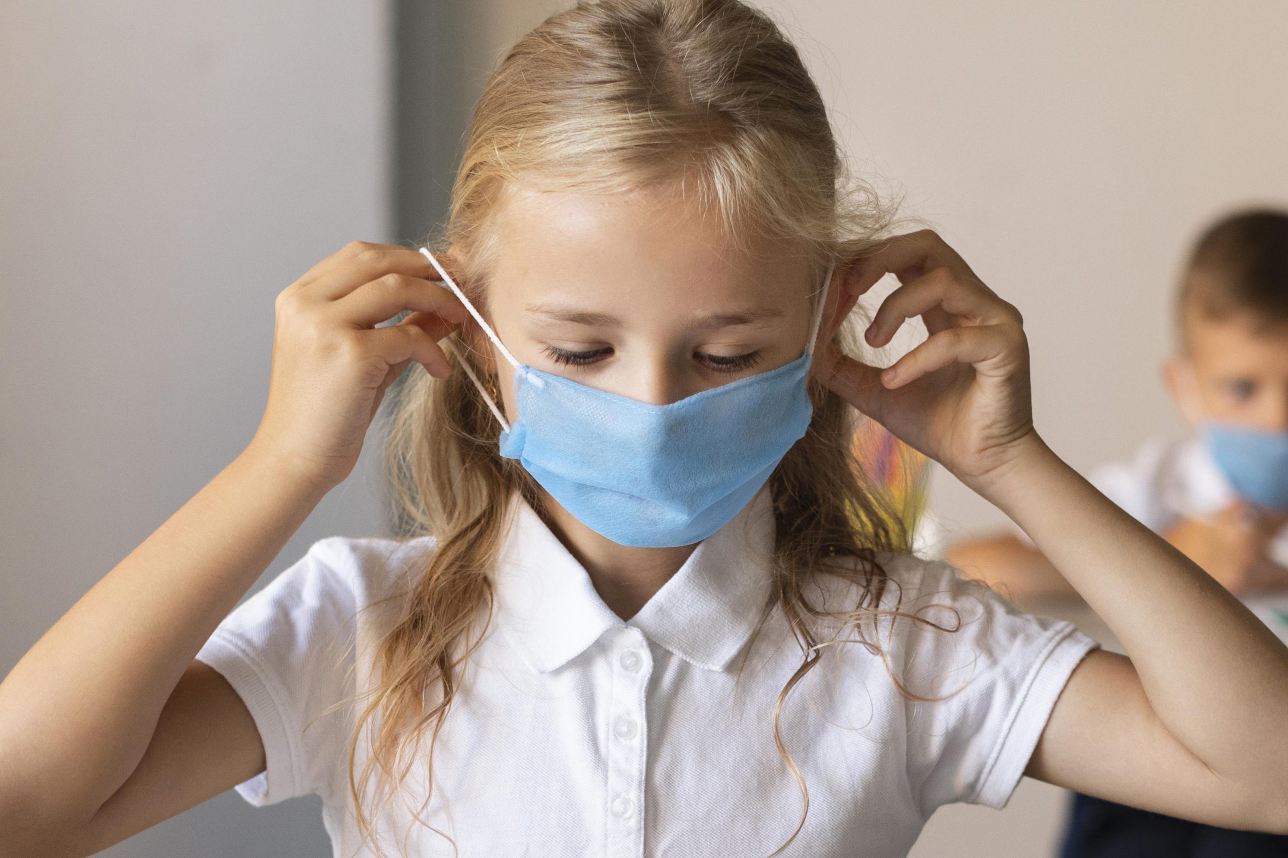 front-view-little-girl-putting-face-mask